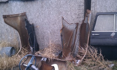 1957 front fenders and grill assembly and one door. Hood visible. 